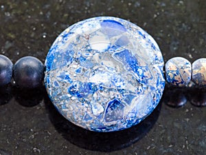 bead from pressed Lazurite stone on dark