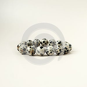 Bead stringing hand bracelet decoration. Hand made gem stone dalmatian jasper fashion accessory. photo