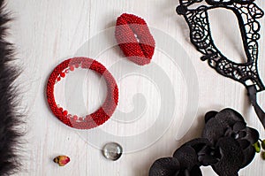 Beaded braselet and brooch set. Red garnet soutache jewelry on the white wooden background. Women accessories