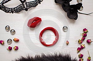 Beaded braselet and brooch set. Red garnet soutache jewelry on the white wooden background. Women accessories