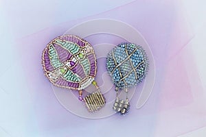 Beaded brooches in the shape of montgolfiers or balloons