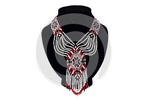 Beaded ethnic red necklace on black velvet bust isolated on white background. Female accessories, decorative ornaments and jewelry