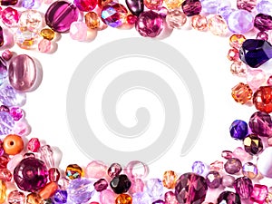 Beads background. Colorful beads in pink, purple, red, violet and lila colors on white