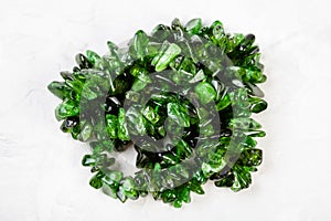 Beads from chrome diopside crystals on gray