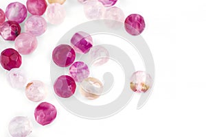 Beads made of natural pink agate on a white background are isolated