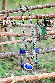 Beads and pendants made from metal and natural minerals on wooden background. Handcraft precious item. Jewelry accessories