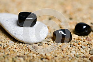 Beads and stones on the sand