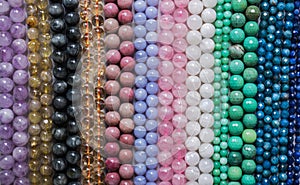 Beads from various types of natural stones are strung on a thread