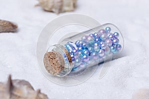 Beads washed up on the beach in a rafting bottle