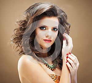 Beaity and fashion concept: Brunette young woman with long, healthy and shiny curly hair. Female with wavy hairstyle