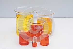 Beaker with color liquid. Solution chemistry. Laboratory beaker with colored liquid over white background