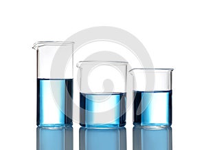 Beakers with blue liquid isolated. Laboratory glassware