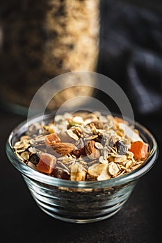 Beakfast cereals in bowl. Healthy muesli with oat flakes, nuts and raisins