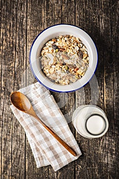 Beakfast cereals in bowl. Healthy muesli with oat flakes, nuts and raisins