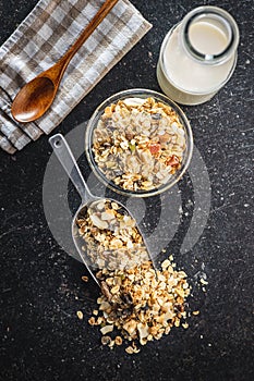 Beakfast cereals in bowl. Healthy muesli with oat flakes, nuts and raisins