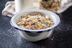 Beakfast cereals in bowl. Healthy muesli with oat flakes, nuts and raisins
