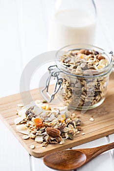 Beakfast cereals on cutting board. Healthy muesli with oat flakes, nuts and raisins