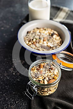 Beakfast cereals in jar. Healthy muesli with oat flakes, nuts and raisins