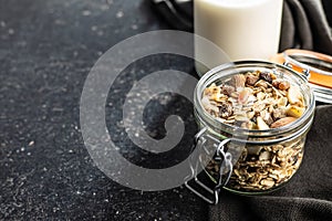 Beakfast cereals in jar. Healthy muesli with oat flakes, nuts and raisins