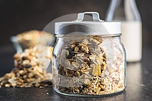 Beakfast cereals in jar. Healthy muesli with oat flakes, nuts and raisins