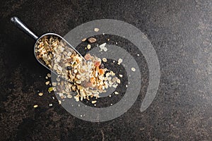 Beakfast cereals in scoop. Healthy muesli with oat flakes, nuts and raisins