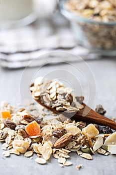 Beakfast cereals in scoop. Healthy muesli with oat flakes, nuts and raisins