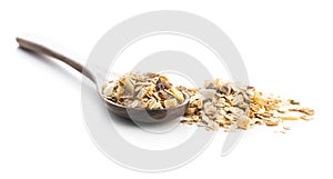 Beakfast cereals in wooden spoon.  Healthy muesli with oat flakes, nuts and raisins