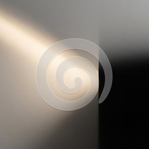 A beam of light breaking through the shadow against a clear background.