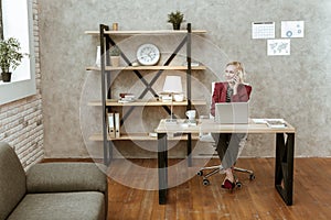 Beaming attractive short-haired woman in dark office costume