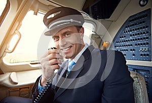 Beaming aviator speaking by portable transmitter