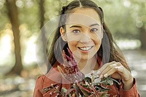 Beaming dark-haired lady showing bright smile while carrying