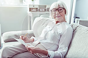 Beaming elderly woman wearing beautiful necklace and bracelet