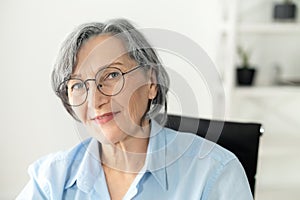 Beaming elegant senior businesswoman in the office