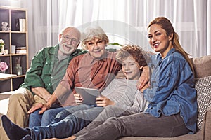 Beaming family resting with appliance together