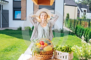 Beaming family woman cooking garden salad out from fresh vegetables outside