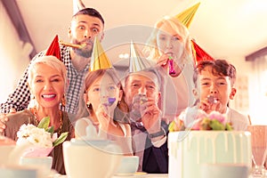 Beaming happy family having much fun celebrating birthday