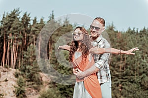 Beaming happy loving couple enjoying their secret hideaway in the forest