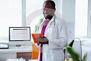 Beaming positive doctor feeling good before starting work