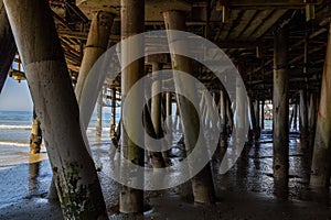 Beams under the pier on the beach in California. Concept, travel, vacation