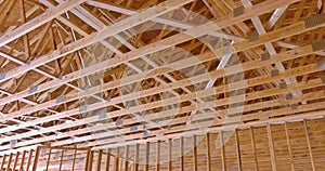 Beams at wooden trusses framework construction on a new house under construction