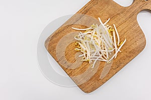 Bean sprouts on wooden chopping board isolated on white