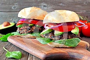 Bean and sweet potato veggie burgers over a wood background
