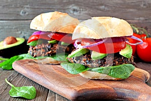 Bean and sweet potato veggie burgers over a wood background photo