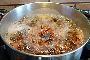 Beans boinling in a pot.