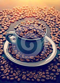 Beans of coffee in mug saucer and table instagram stile