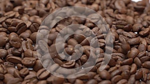 Beans of coffee raining at slow motion. Conceptual clip of coffee beans close up