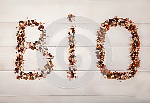 Beans, lentils, mung bean, peas laid out on a white wooden background in the form of the inscription bio. Vegetarian Food Concept