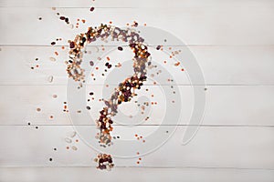 Beans, lentils, peas laid out on a white wooden background in the form of a question mark. Concept - Healthy Eating. horizontally