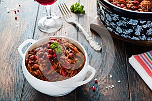 Beans with pork stewed in spicy tomato sauce with onion, paprika, beer, bell and pink pepper.