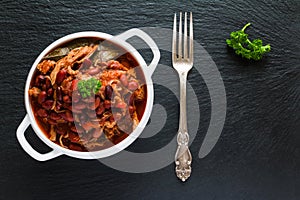 Beans with pork stewed in spicy tomato sauce with onion, paprika, beer, bell and pink pepper.